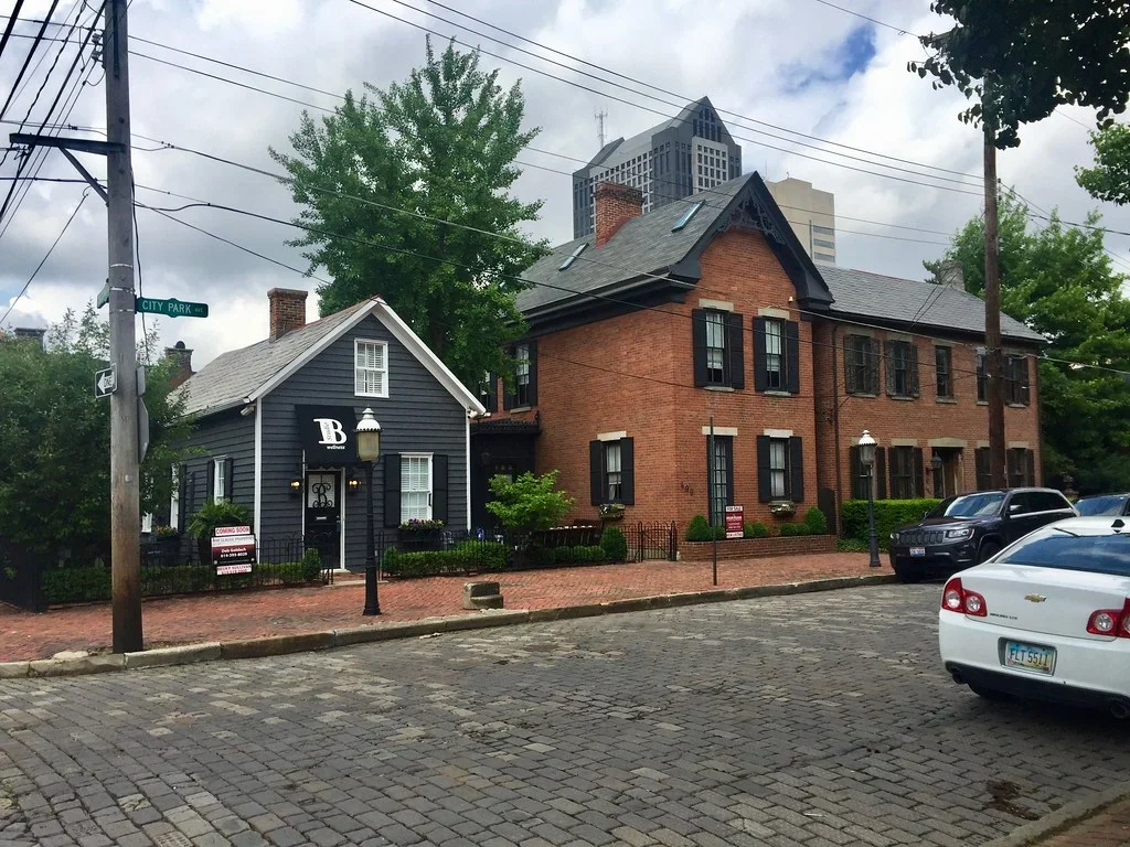 Historic houses and pavement at a City Park Avenue corner in Columbus