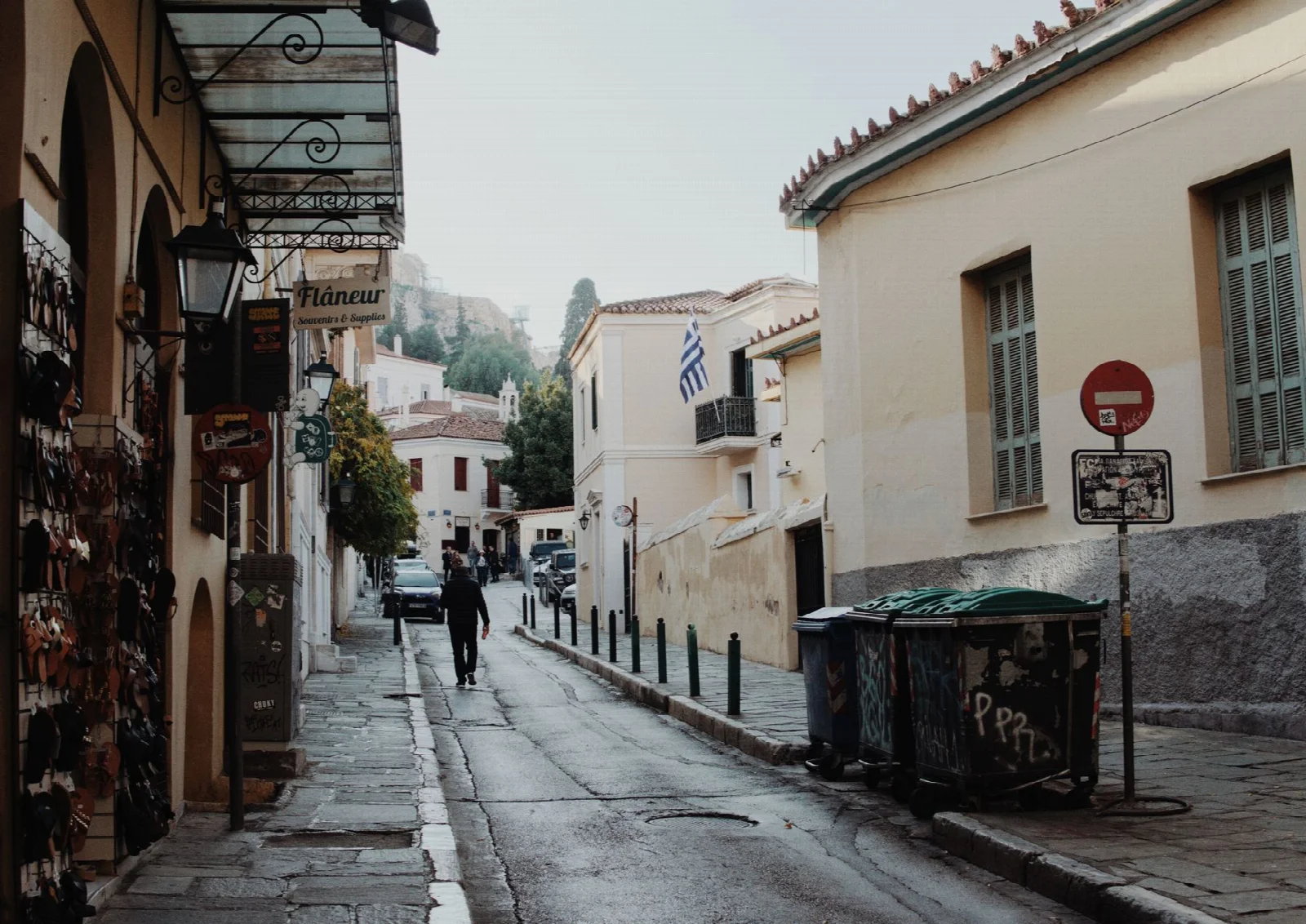 A narrow street between colorful facades in Plaka, Athens