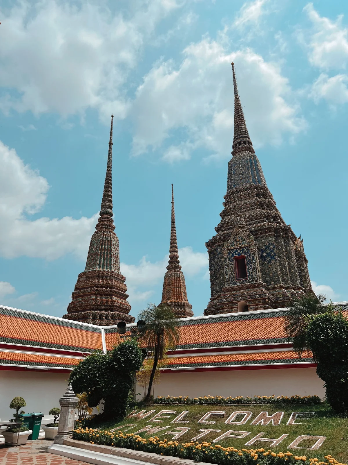 Decorated spires of Wat Pho temple rising against the Bangkok sky