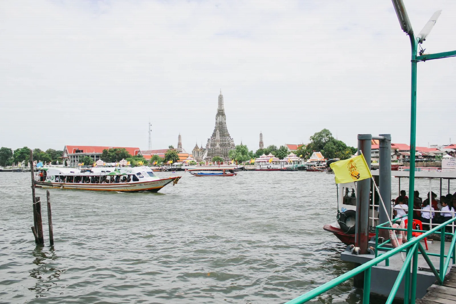 Boats on the Chao Phraya River and the opposite bank in Bangkok