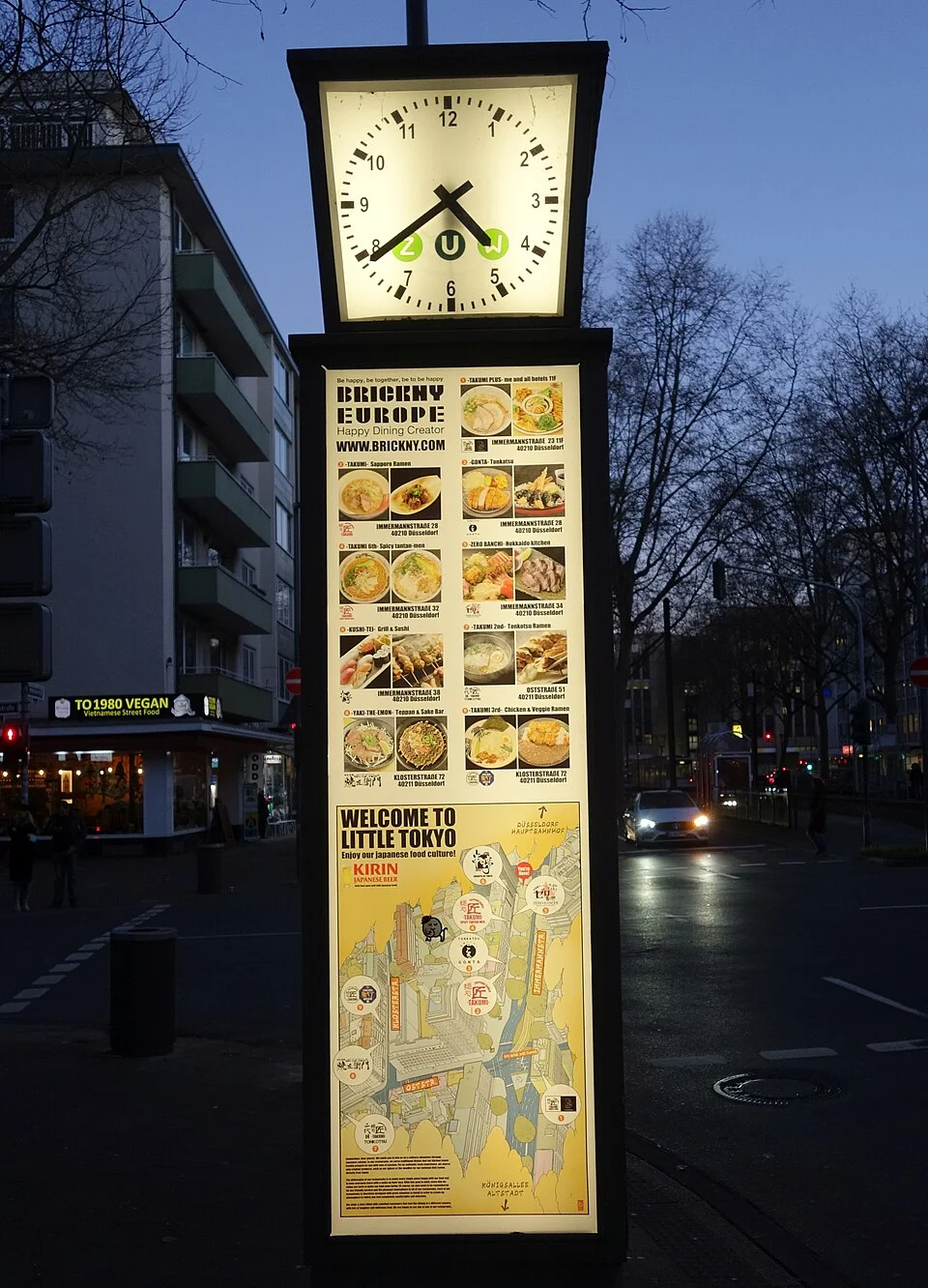 Welcome to Little Tokyo sign and clock on Düsseldorf’s Immermannstraße, photographed in December 2021.
