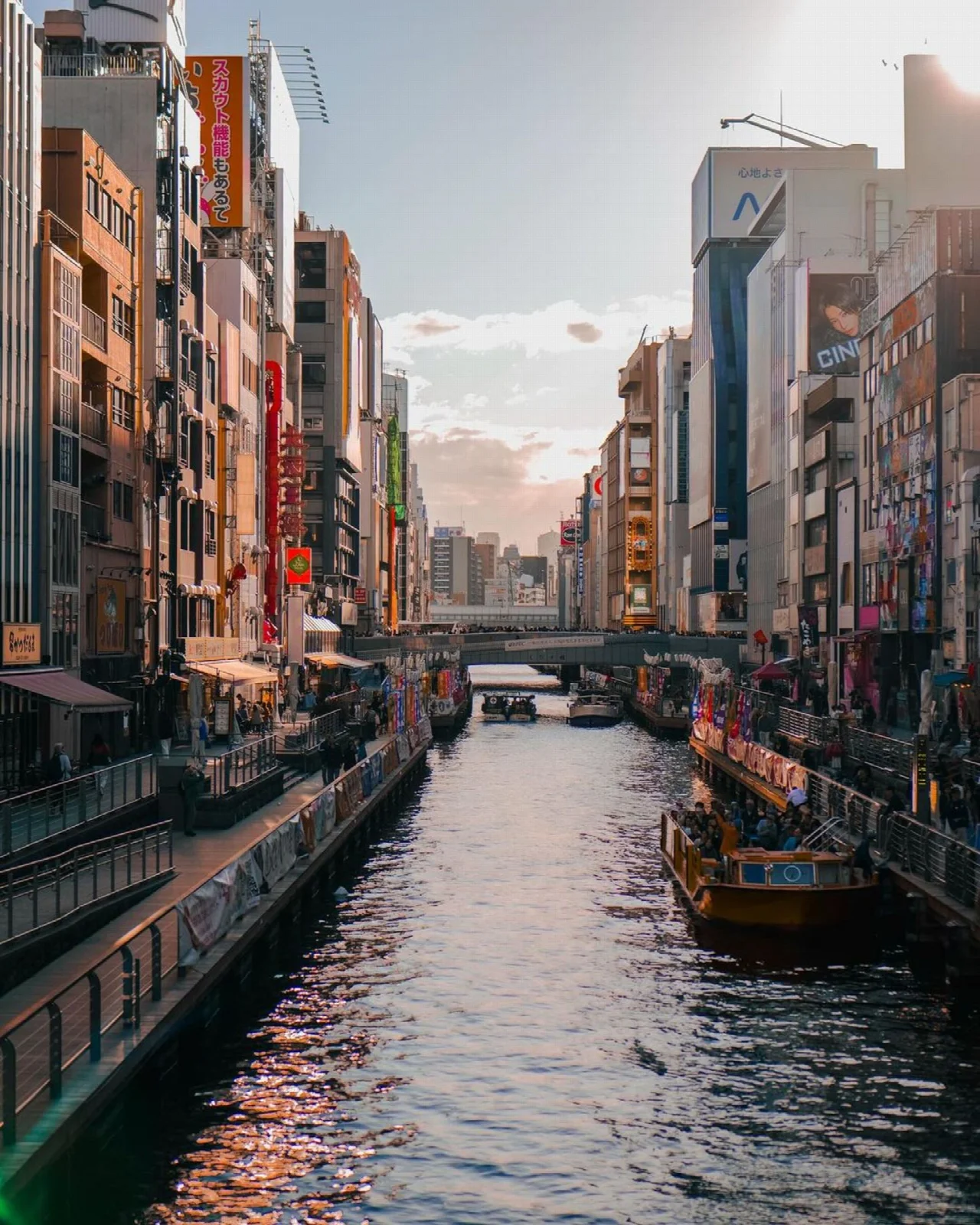 A boat on the Dotonbori canal and waterfront buildings in Osaka