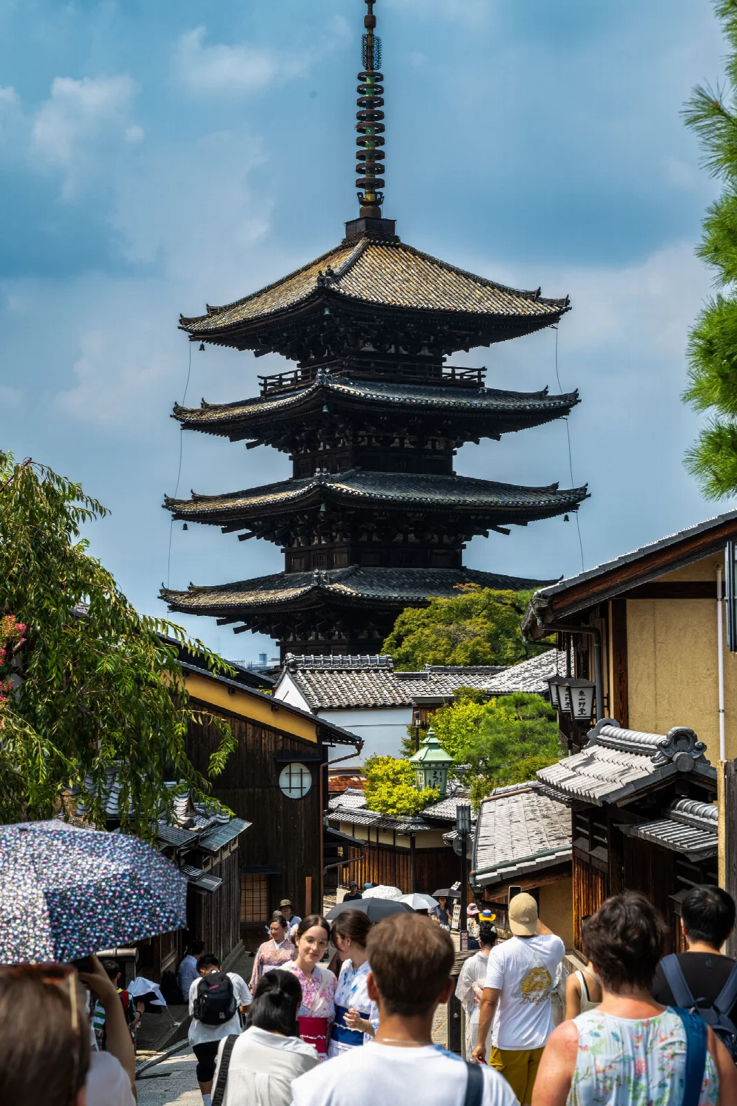 Visitors on a Kyoto Higashiyama street with Yasaka Pagoda in the background