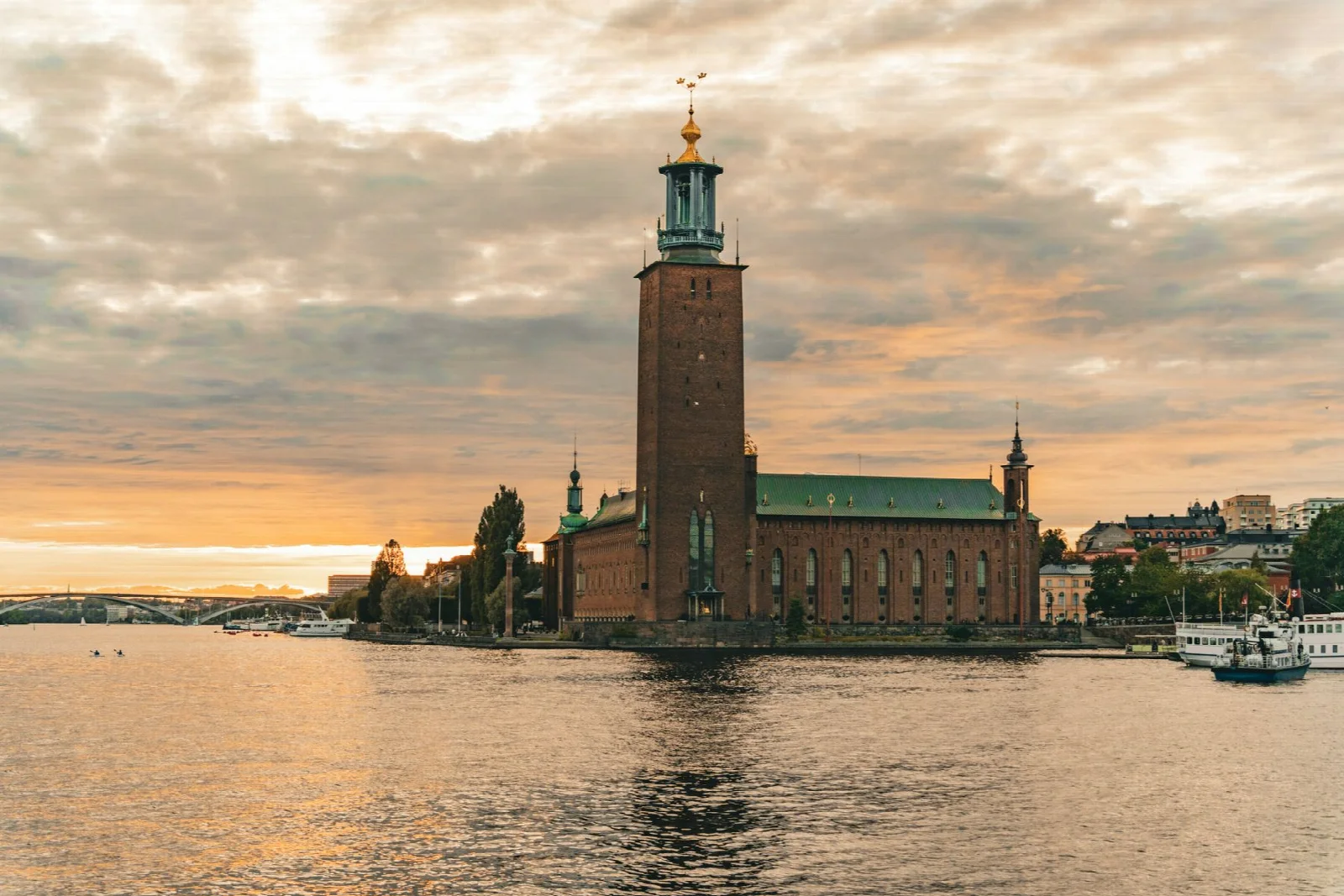 The silhouette of Stockholm City Hall reflected in the water at sunset