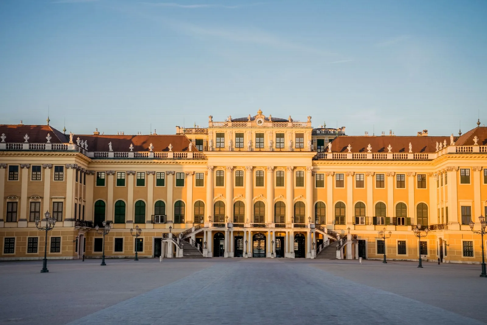The yellow main facade of Schönbrunn Palace in Vienna in daylight